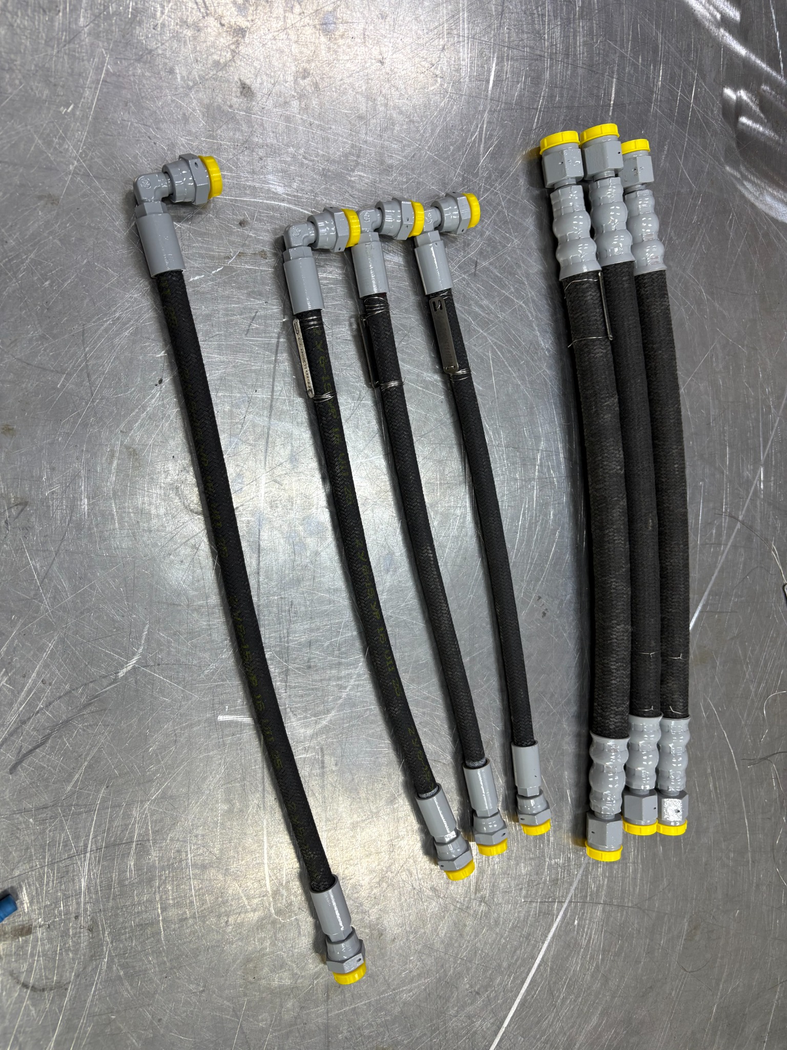 A selection of rubber hose assemblies with straight and angled end fittings